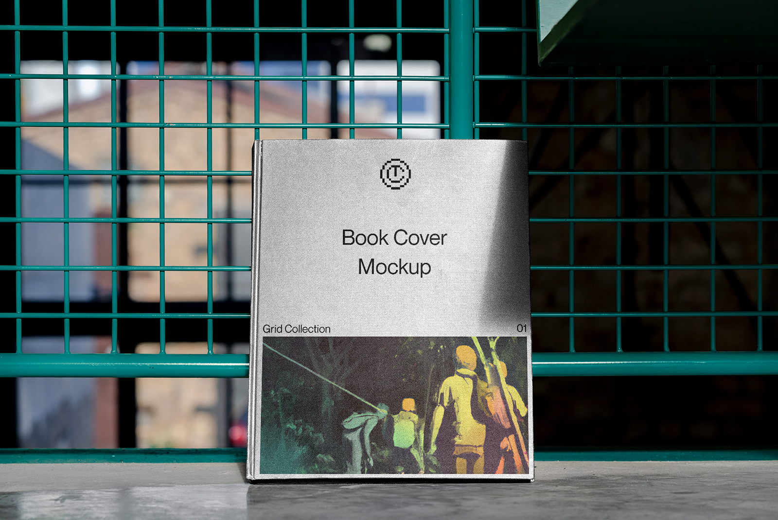 Realistic book cover mockup displayed on urban metal grid, showcasing editable template design for branding, standing book, outdoor scene.